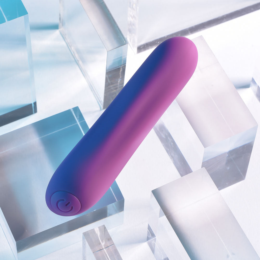 Playboy Pleasure PLAYBOY BULLET -  9 cm USB Rechargeable Bullet on clear geometric blocks.