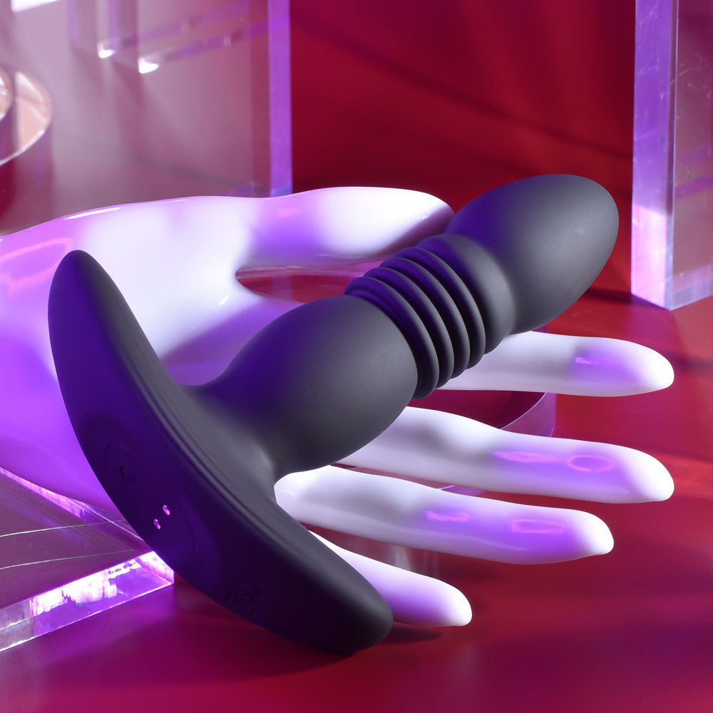 Playboy Pleasure TRUST THE THRUST -  13.7 cm USB Rechargeable Thrusting Butt Plug with Wireless Remote on display.