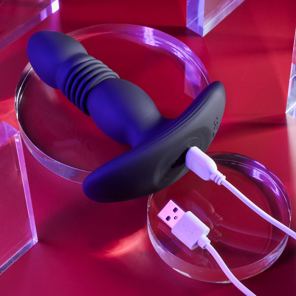 Playboy Pleasure TRUST THE THRUST -  13.7 cm USB Rechargeable Thrusting Butt Plug with Wireless Remote charging on display.