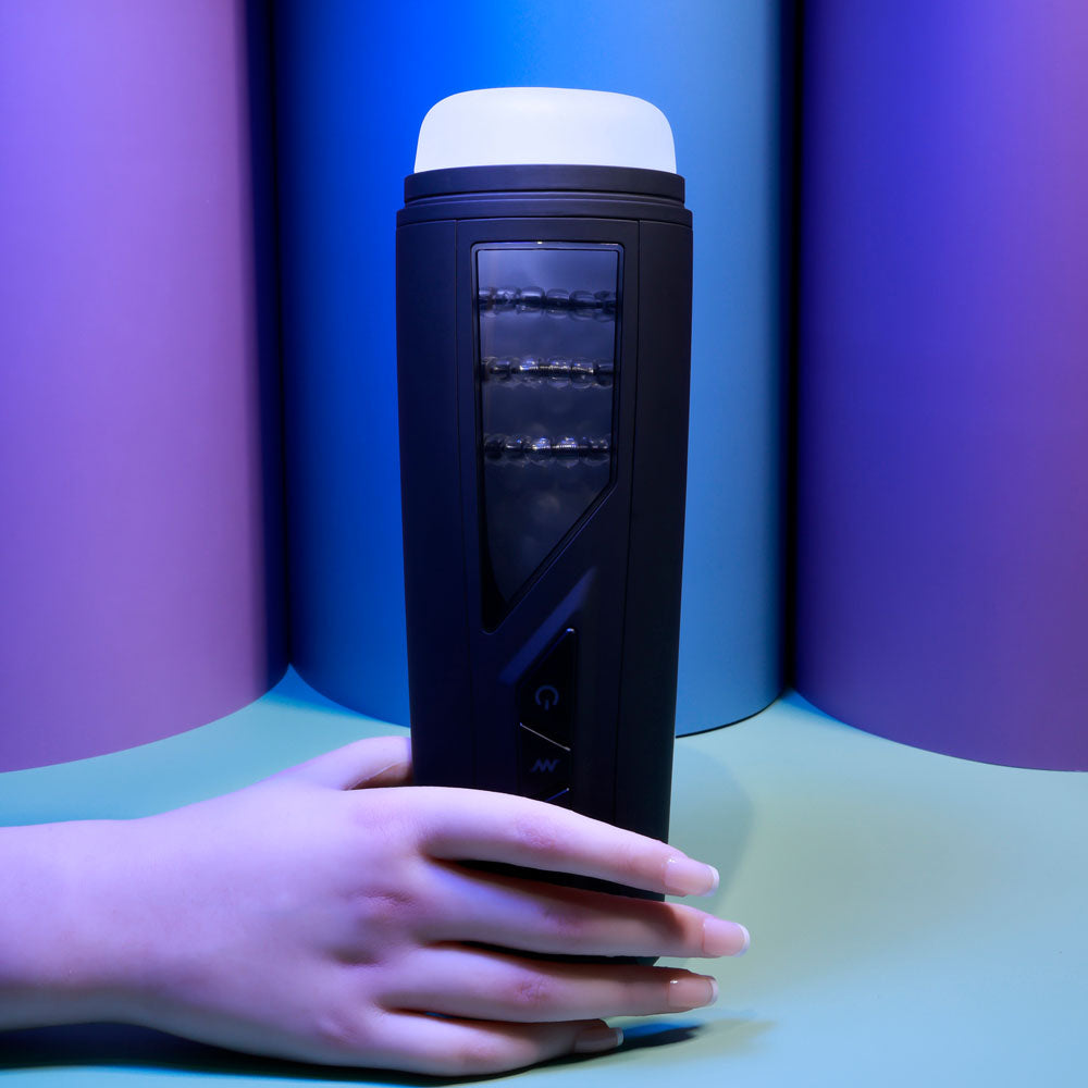 Playboy Pleasure PURSUIT OF PLEASURE - USB Rechargeable Vibrating Stroker held in hand with colorful background