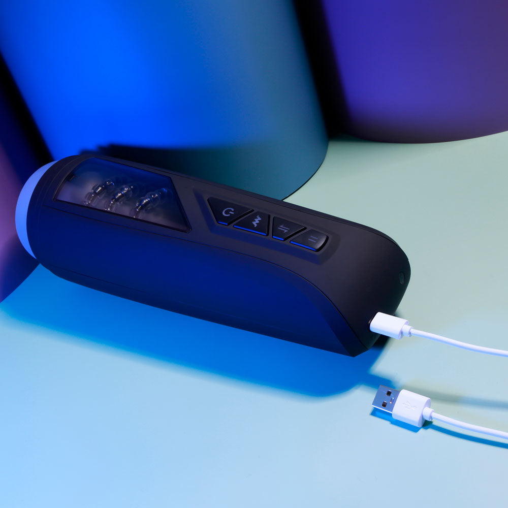 Playboy Pleasure PURSUIT OF PLEASURE - USB Rechargeable Vibrating Stroker with buttons and charging cable on colorful background.