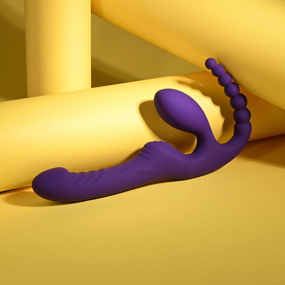 Playboy Pleasure HUG IT OUT -  29 cm USB Rechargeable Strapless Strap-On on yellow background.