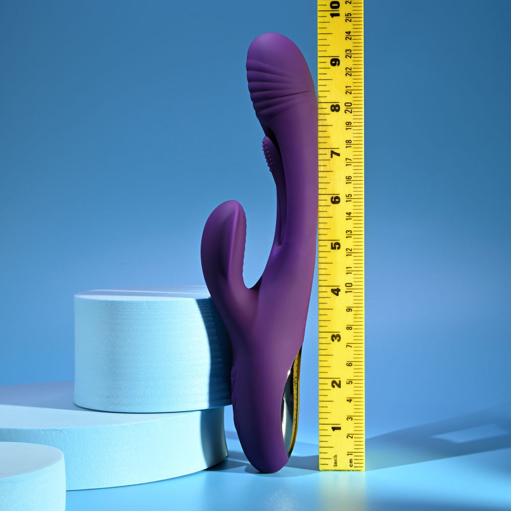 Playboy Pleasure THE THRILL - 24.4 cm USB Rechargeable Rabbit Vibrator alongside measuring tape for size reference.