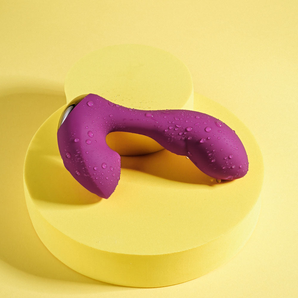 Playboy Pleasure ARCH -  14.1 cm USB Rechargeable G-Spot Vibrator on a vibrant yellow background.