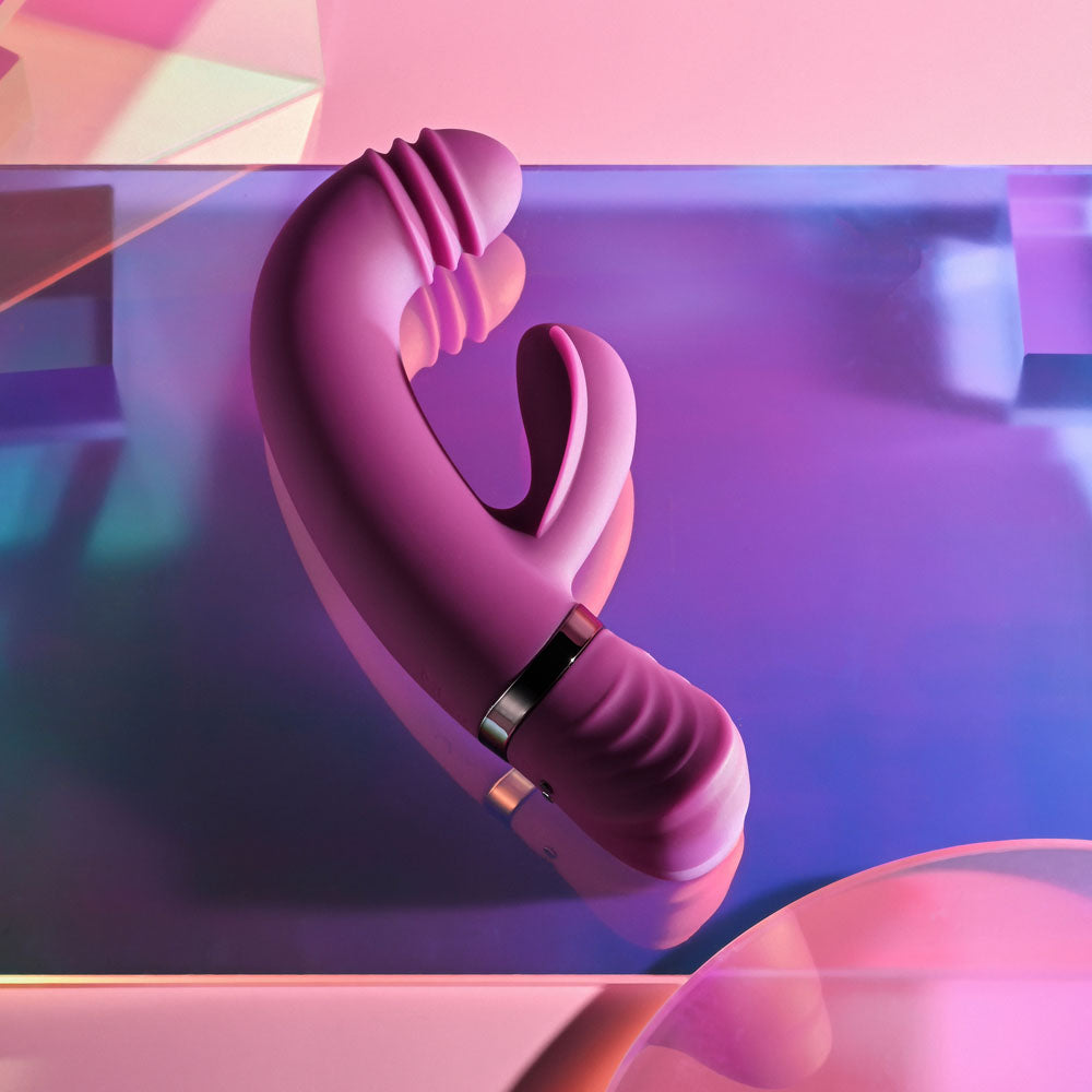 Playboy Pleasure TAP THAT - 16.5 cm USB Rechargeable Rabbit Vibrator on a colorful background.