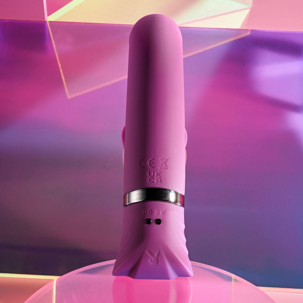 Playboy Pleasure TAP THAT -  16.5 cm USB Rechargeable Rabbit Vibrator in vibrant pink on a colorful background.