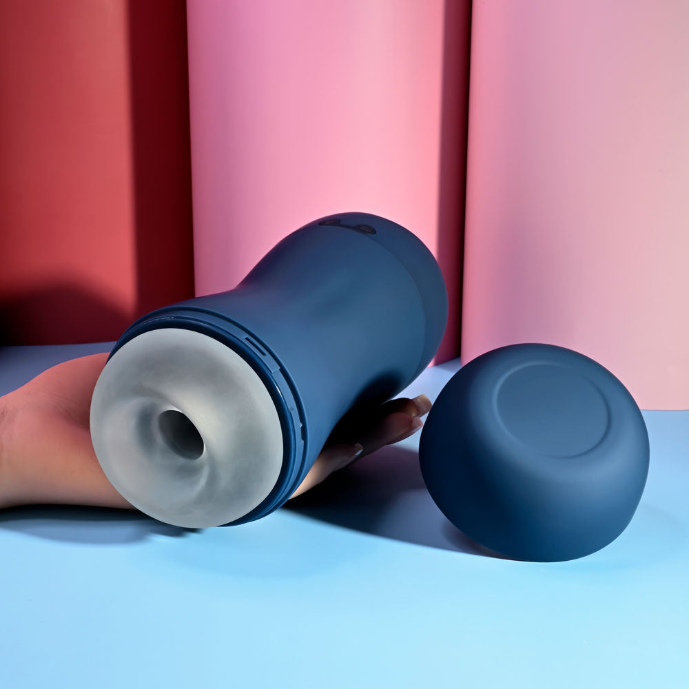 Playboy Pleasure GUSTO - USB Rechargeable Vibrating & Sucking Masturbator on a blue background.