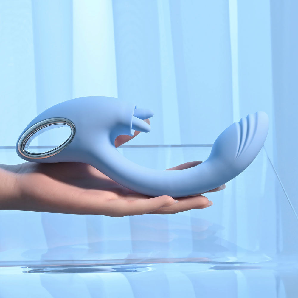 Playboy Pleasure SAPPHIRE SKY -  21.6 cm USB Rechargeable Vibrator with Double Tongue Stimulator in blue held in hand.