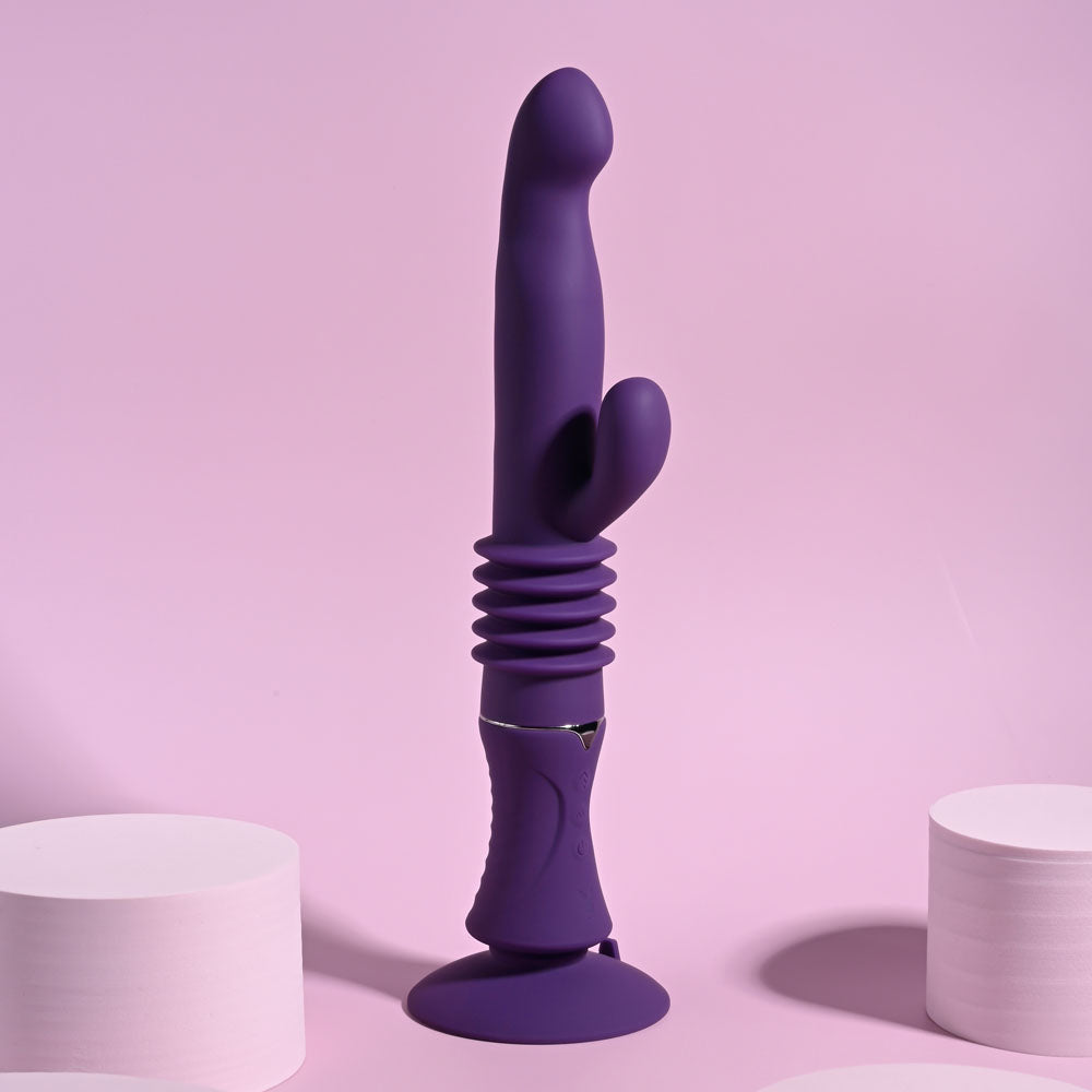 Playboy Pleasure HOPPY ENDING -  29.2 cm USB Rechargeable Thrusting Rabbit Vibrator on a pink background.