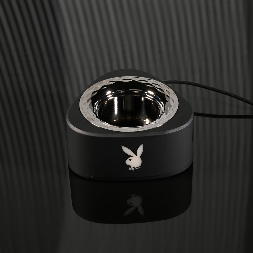 Playboy Pleasure PLEASURE ZONE - USB charging dock for 21.4 cm rechargeable vibrator on a sleek black surface.