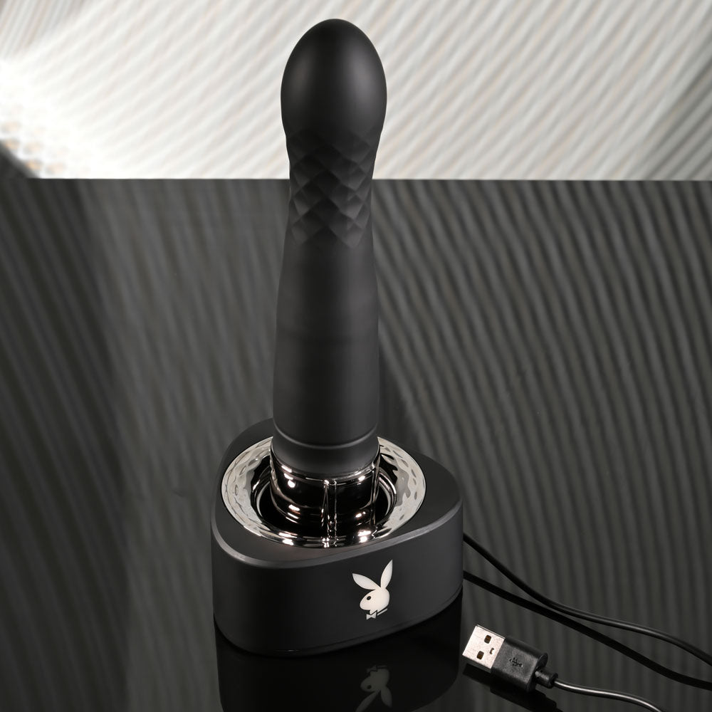 Playboy Pleasure PLEASURE ZONE - 21.4 cm Rechargeable Vibrator with USB Charging Dock on a sleek charging base.