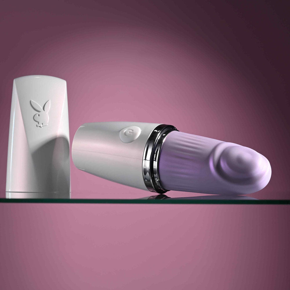 Playboy Pleasure GETAWAY - White/ 14.2 cm USB Rechargeable Tapping Stimulator displayed elegantly on a shelf.