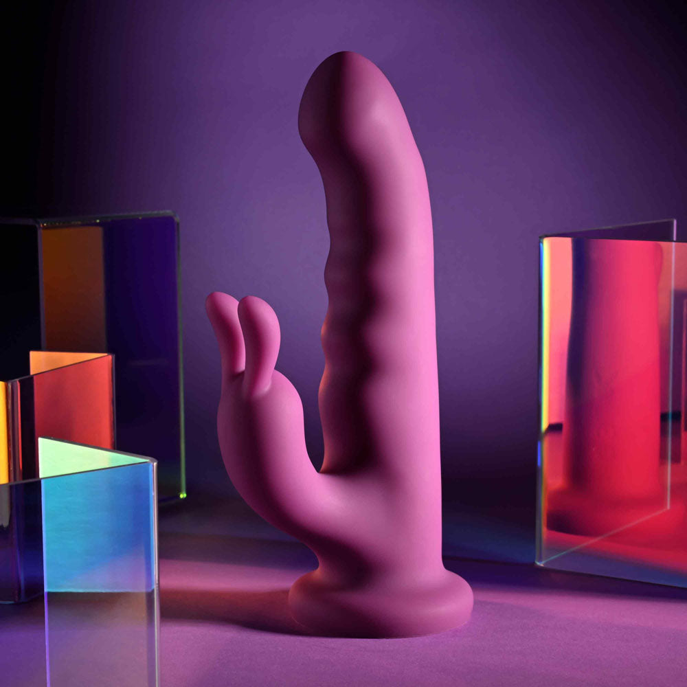 Playboy Pleasure FLUFFLE - 19.7 cm USB Rechargeable Rabbit Vibrator displayed with colorful translucent blocks.