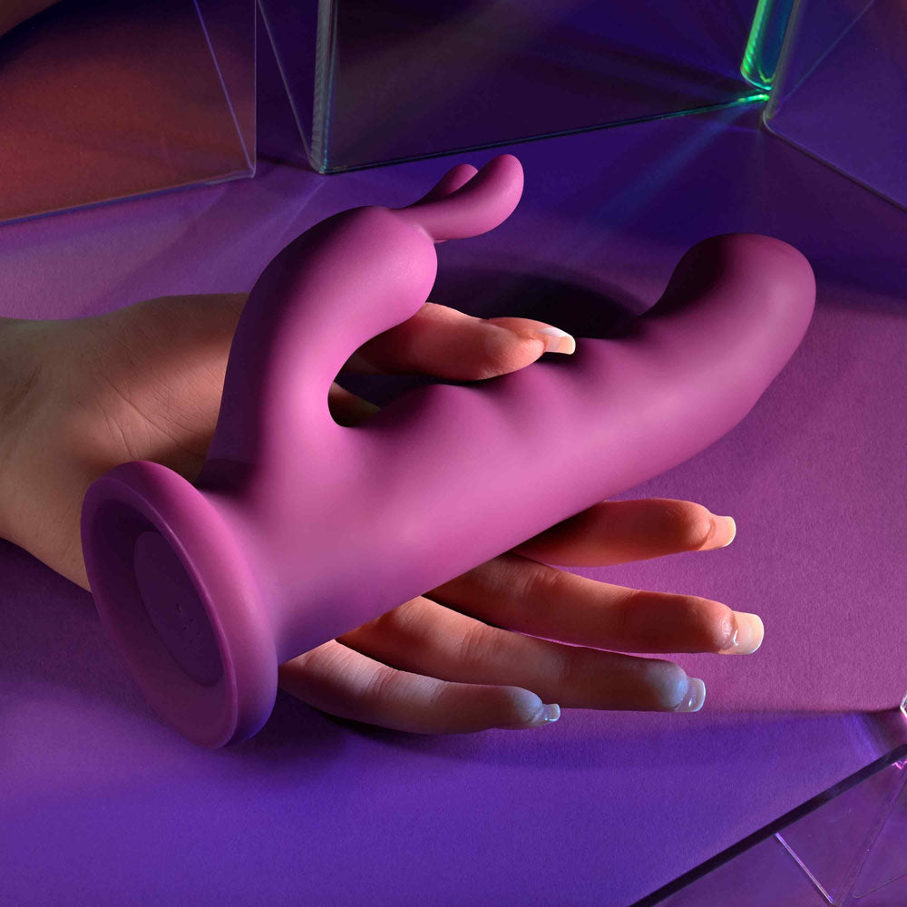 Playboy Pleasure FLUFFLE -  19.7 cm USB Rechargeable Rabbit Vibrator in a hand, showcasing its soft silicone design.