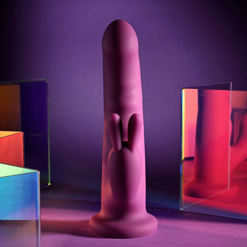 Playboy Pleasure FLUFFLE -  19.7 cm USB Rechargeable Rabbit Vibrator on display with colorful backgrounds.