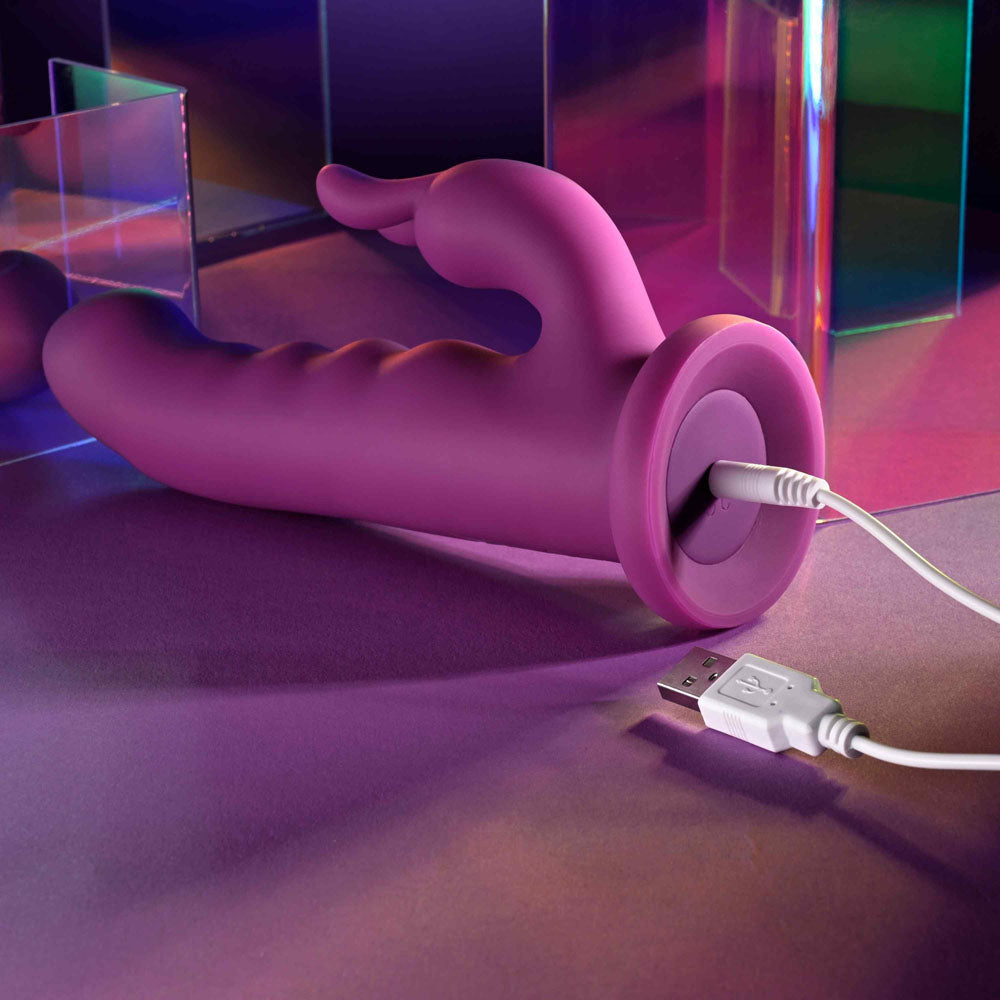 Playboy Pleasure FLUFFLE - 19.7 cm USB Rechargeable Rabbit Vibrator charging on a colorful background.