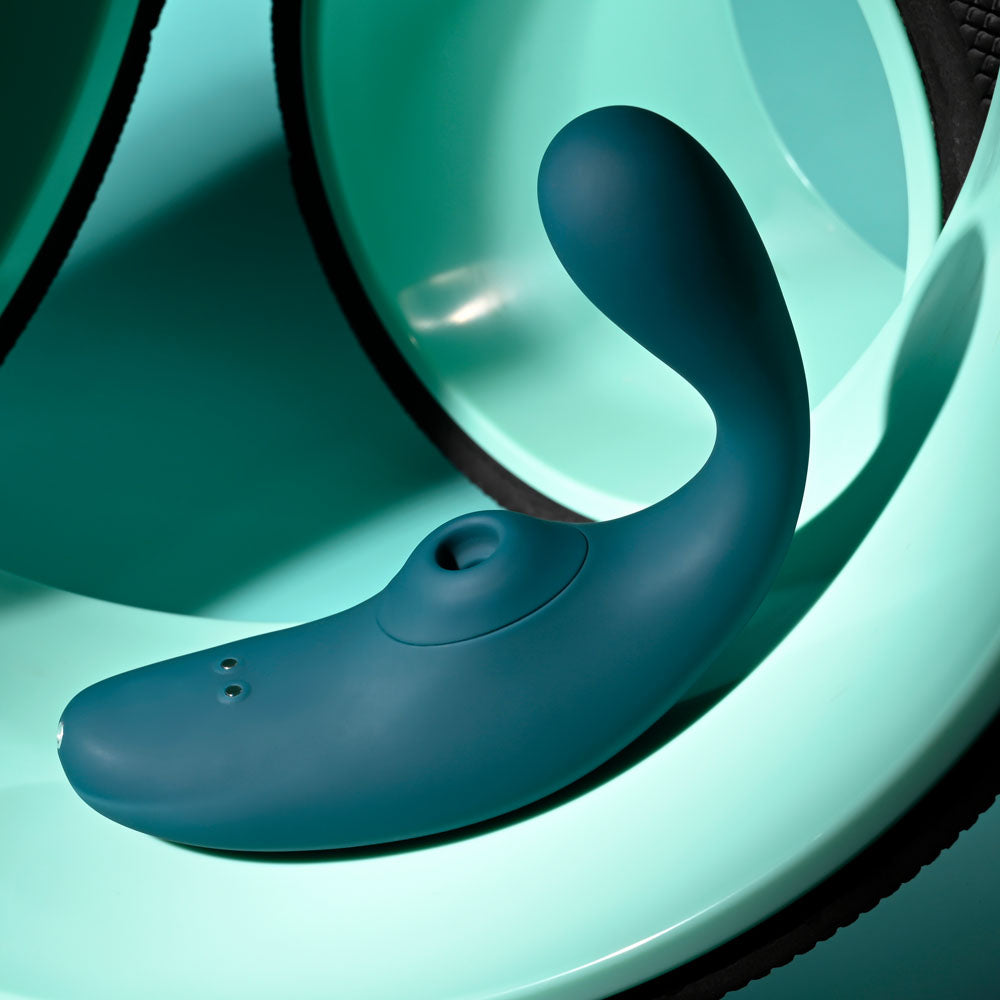 Playboy Pleasure CHARMER - USB Rechargeable Vibrator with Clitoral Suction on a teal background.