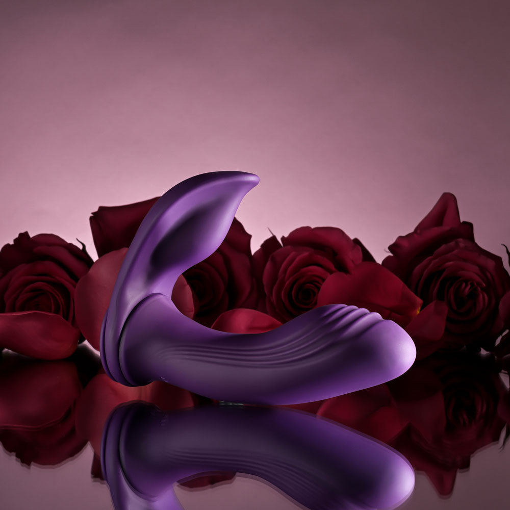 Playboy Pleasure MIX & MATCH - USB Rechargeable with C-Ring Attachment surrounded by red roses.