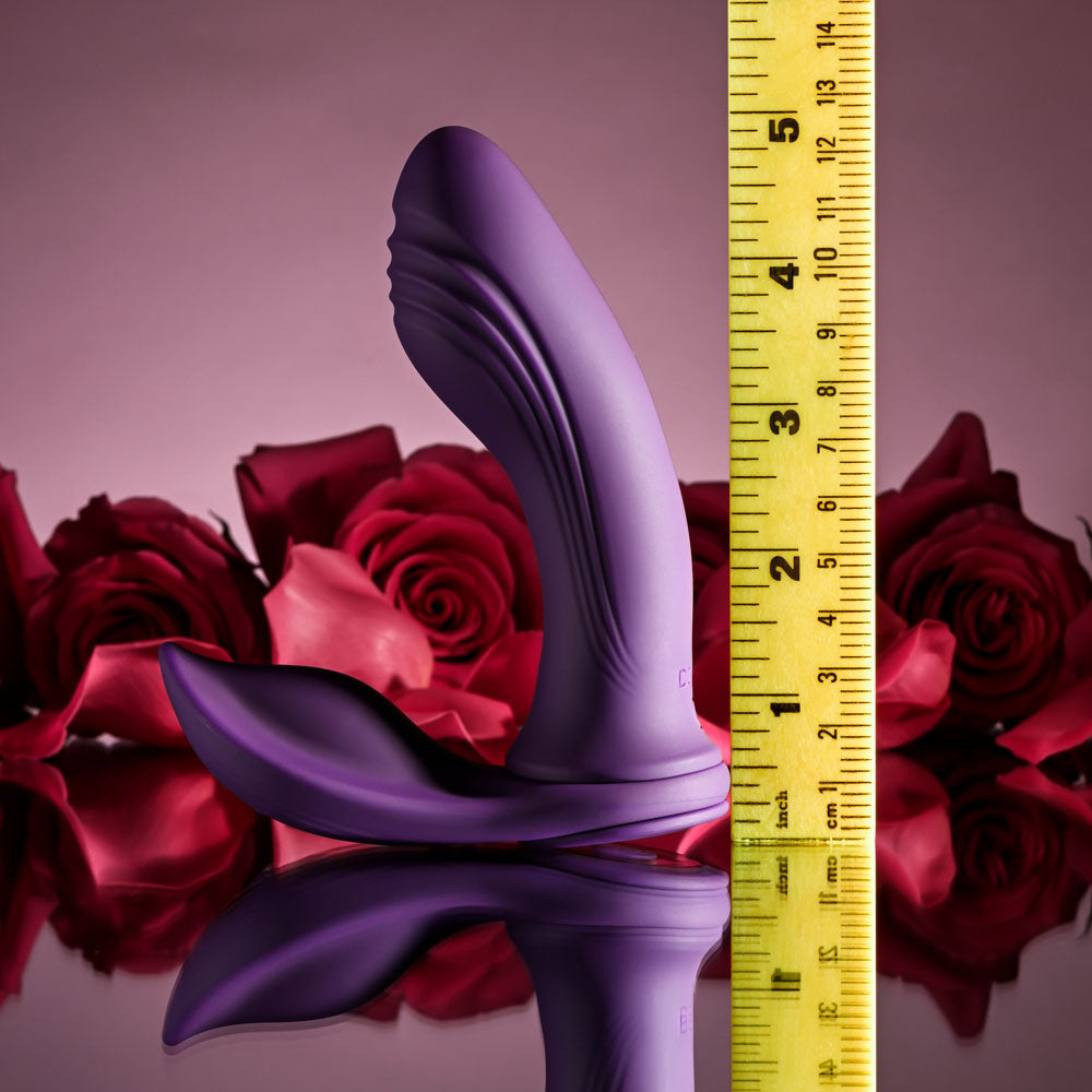 Playboy Pleasure MIX & MATCH - USB Rechargeable with C-Ring Attachment surrounded by roses and a measuring tape.