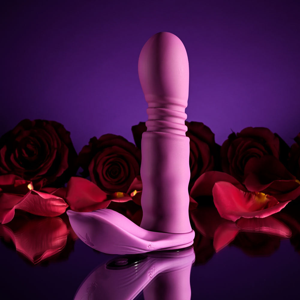 Playboy Pleasure MATCH PLAY -  USB Rechargeable with C-Ring Attachment surrounded by rose petals.