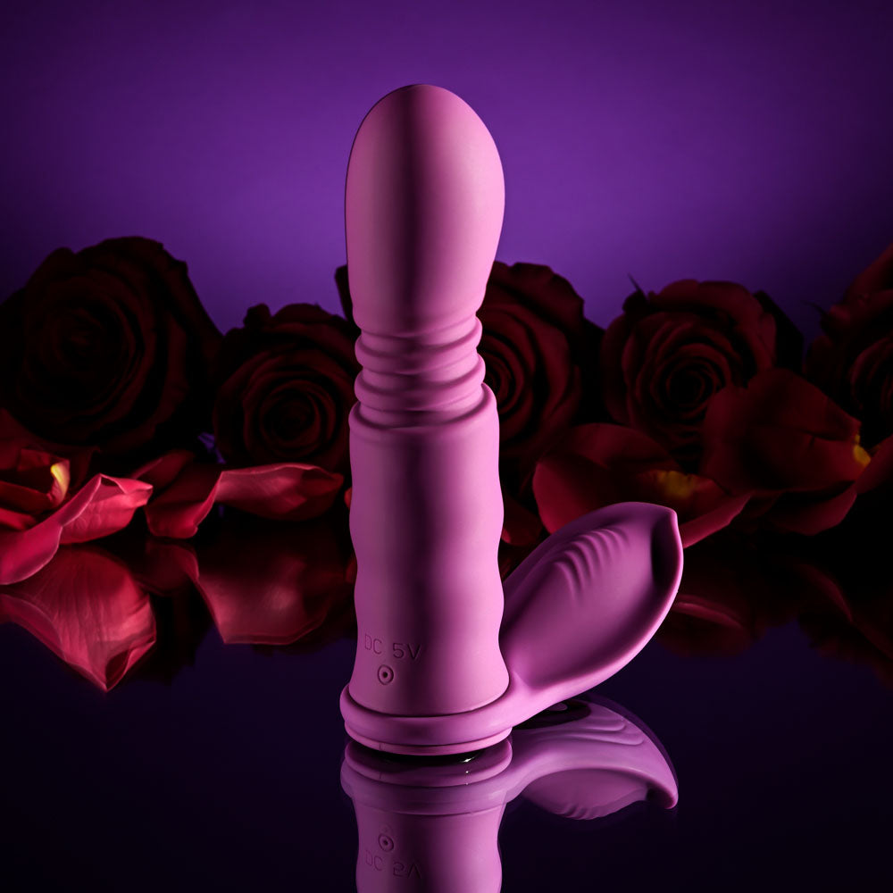 Playboy Pleasure MATCH PLAY - USB Rechargeable with C-Ring Attachment against a backdrop of roses.