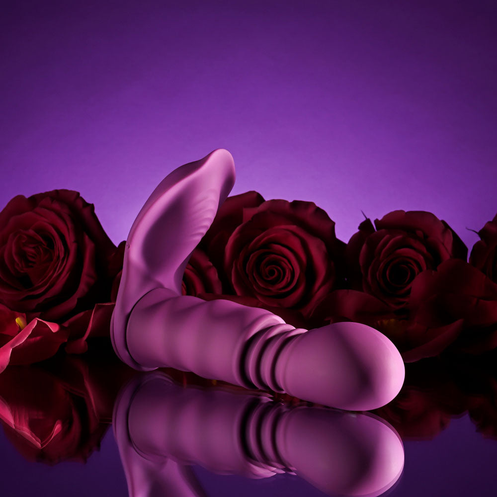 Playboy Pleasure MATCH PLAY -  USB Rechargeable with C-Ring Attachment next to red roses on a reflective surface.