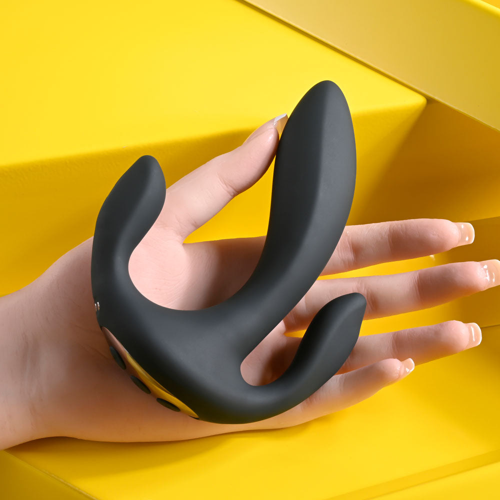 USB rechargeable triple probe vibrator in a hand, showcasing its sleek design and multi-stimulation features.