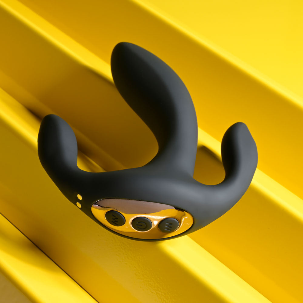 Playboy Pleasure TRIPLE THREAT - USB Rechargeable Triple Probe Vibrator on a vibrant yellow surface.