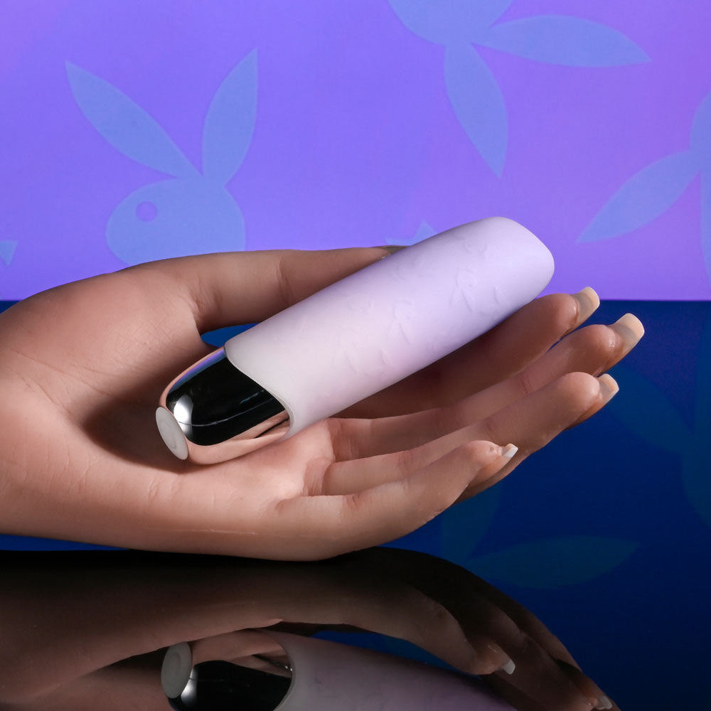 Playboy Pleasure BUNNY BUNCH - Pearl 11.3 cm USB Rechargeable Bullet held in a hand, showcasing its luxurious design.