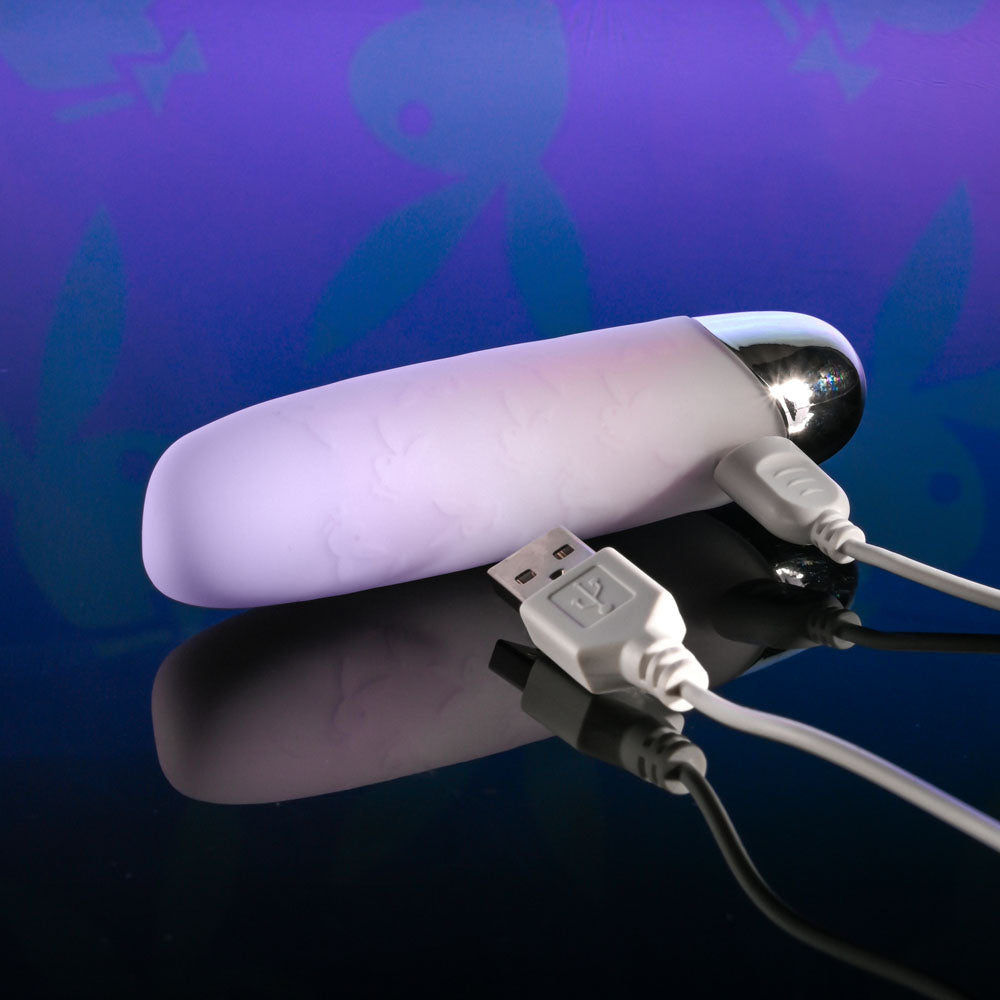 Playboy Pleasure BUNNY BUNCH - Pearl 11.3 cm USB Rechargeable Bullet charging on a reflective surface.