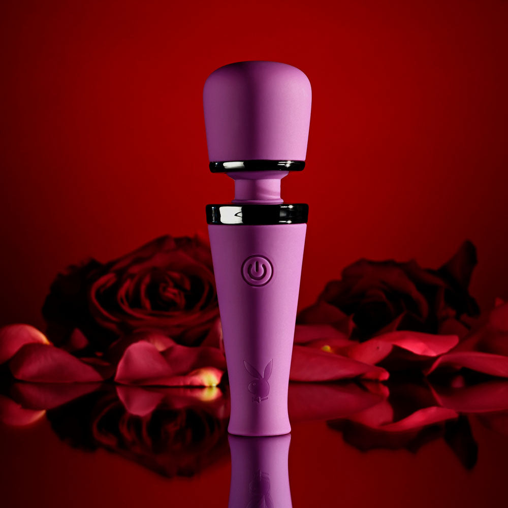 Playboy Pleasure MIC DROP -  11.4 cm USB Rechargeable Vibrating Mini Massage Wand against a backdrop of red roses.