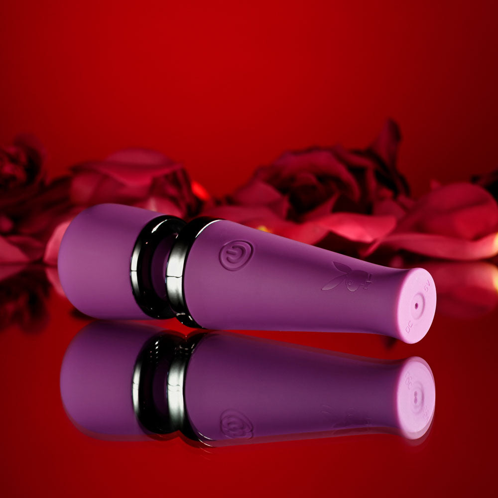 Playboy Pleasure MIC DROP -  11.4 cm USB Rechargeable Vibrating Mini Massage Wand against a floral background.