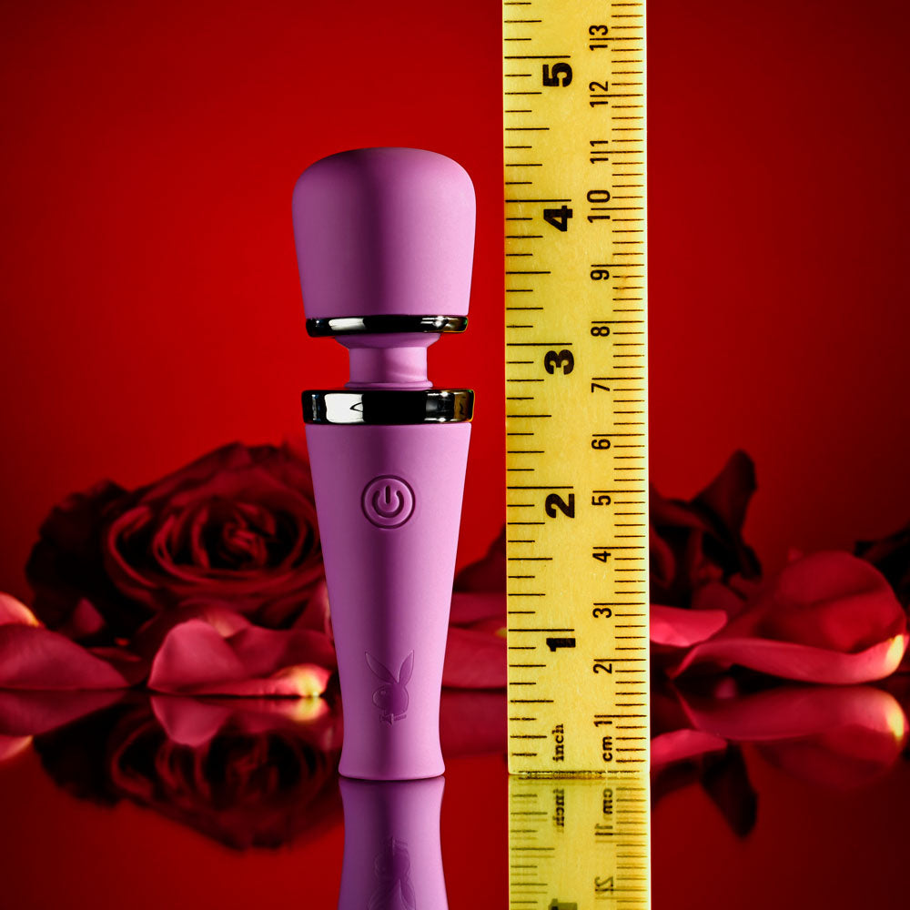 Playboy Pleasure MIC DROP -  11.4 cm USB Rechargeable Vibrating Mini Massage Wand next to a measuring tape on a red rose background.