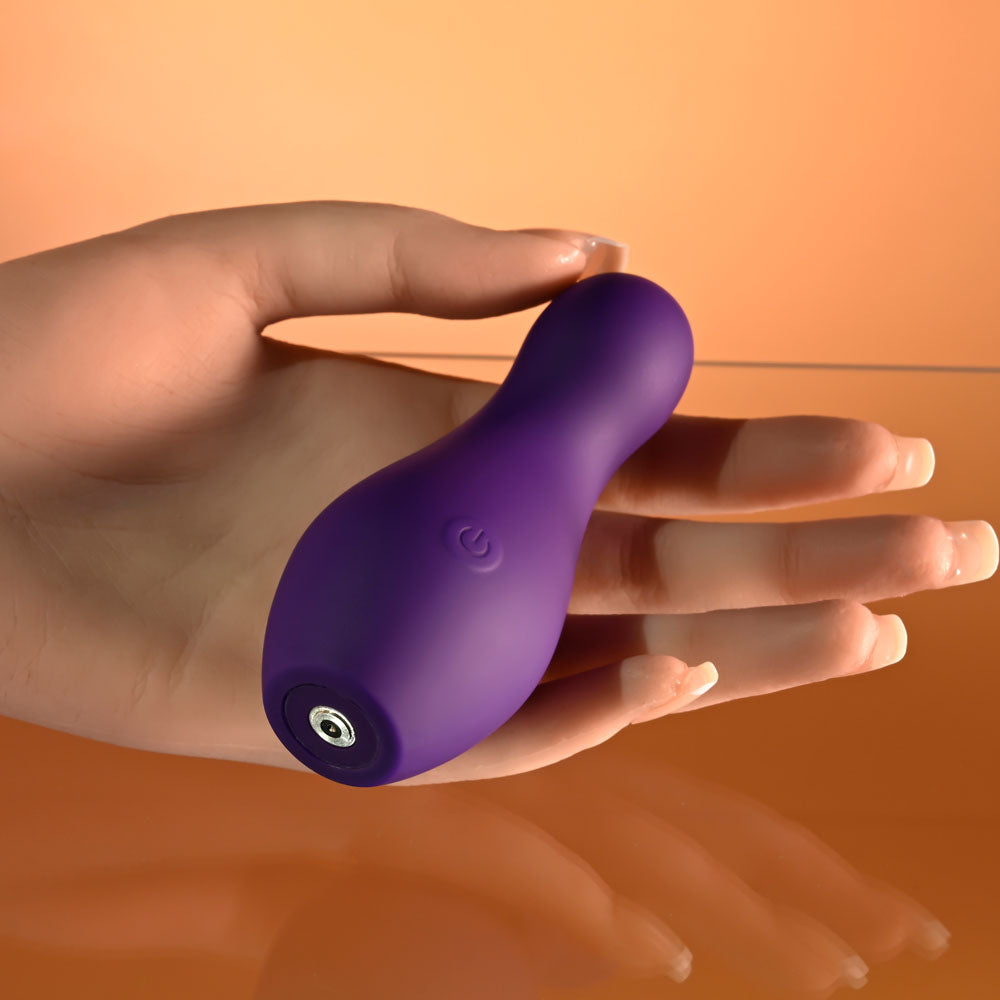 Playboy Pleasure THE JET SET - VIBRATOR - 10.2 cm Vibrator with Self Charging Case in hand, showcasing its sleek design.
