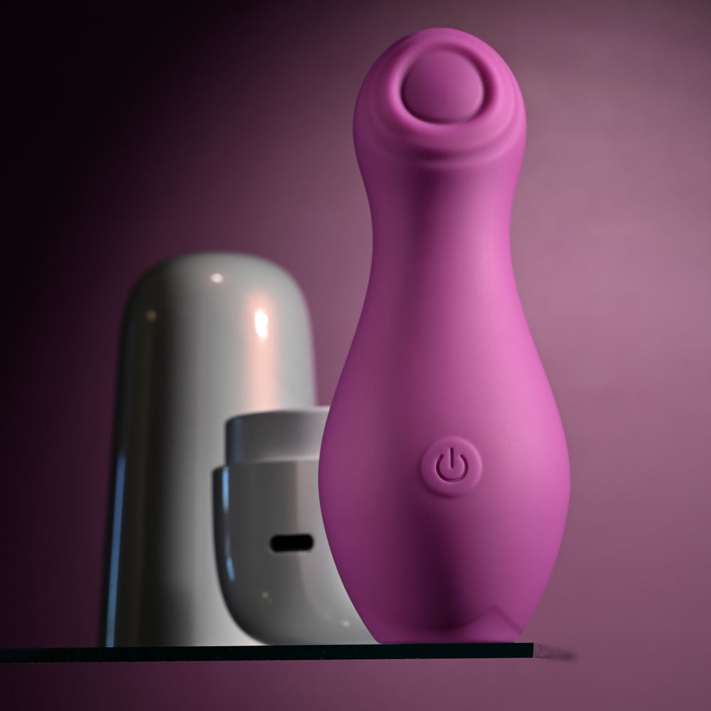 Playboy Pleasure THE JET SET - TAPPING -  10.2 cm Tapping Stimulator with Charging Case on a shelf.