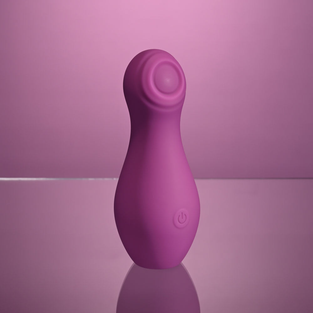 Playboy Pleasure THE JET SET - TAPPING - 10.2 cm Tapping Stimulator with Charging Case in vibrant pink silicone.