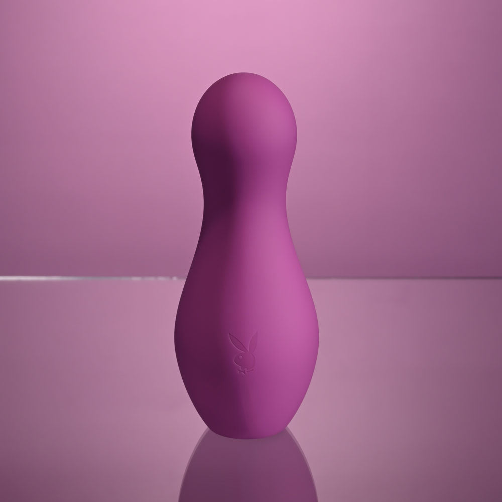 Playboy Pleasure THE JET SET - TAPPING - 10.2 cm Tapping Stimulator with Charging Case in vibrant purple.