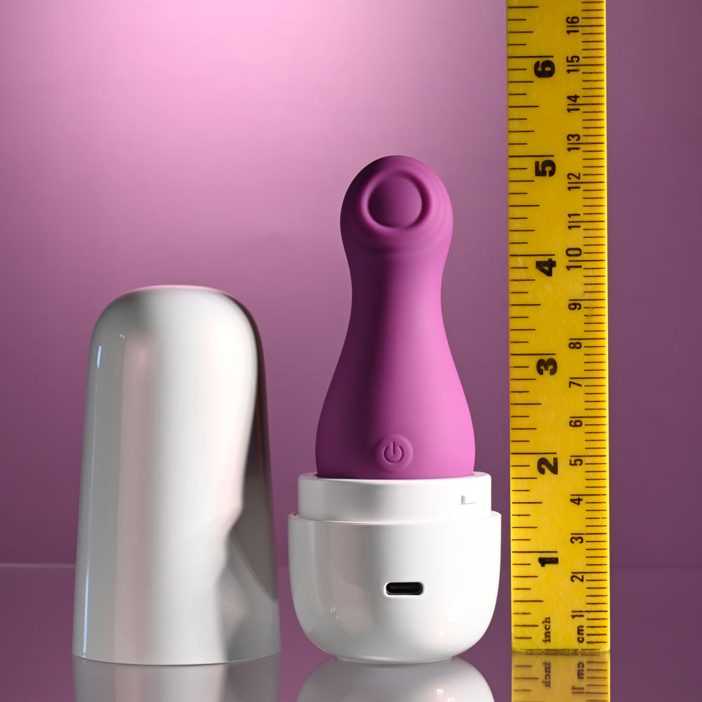 Playboy Pleasure THE JET SET - TAPPING - 10.2 cm Tapping Stimulator with Charging Case next to measuring tape.
