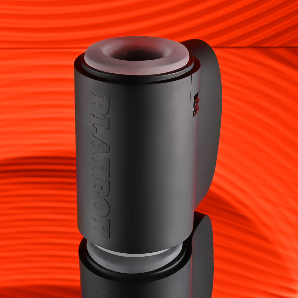 Playboy Pleasure COME ALONG - USB Rechargeable Vibrating Stroker on vibrant red background.