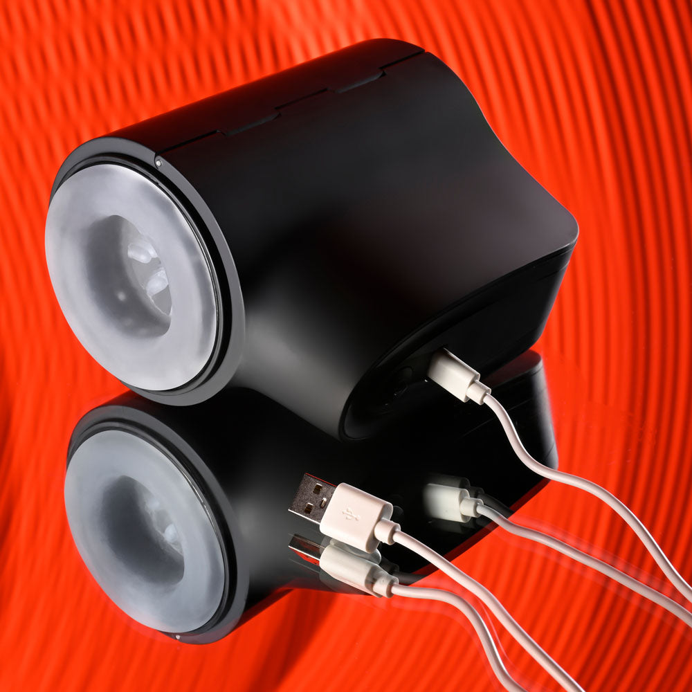Playboy Pleasure COME ALONG - USB Rechargeable Vibrating Stroker with charging cables on a reflective surface.
