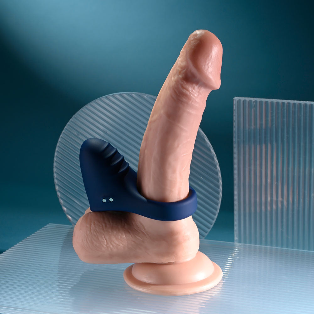 Playboy Pleasure PLEASURE POINT USB rechargeable vibrating cock ring displayed on a base, showcasing its design and flexibility.