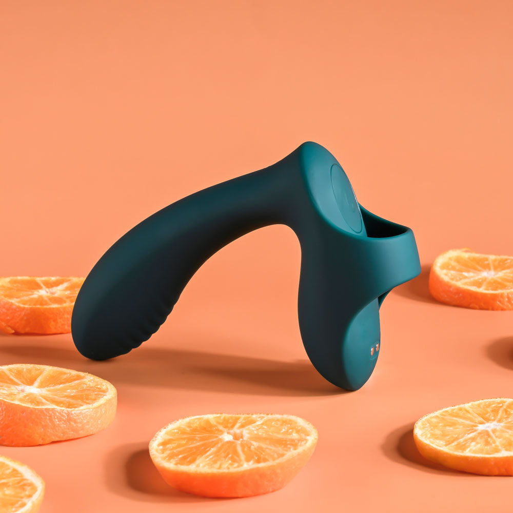 Playboy Pleasure WRAPPED AROUND YOUR FINGER -  USB Rechargeable Finger Stimulator with orange slices backdrop.