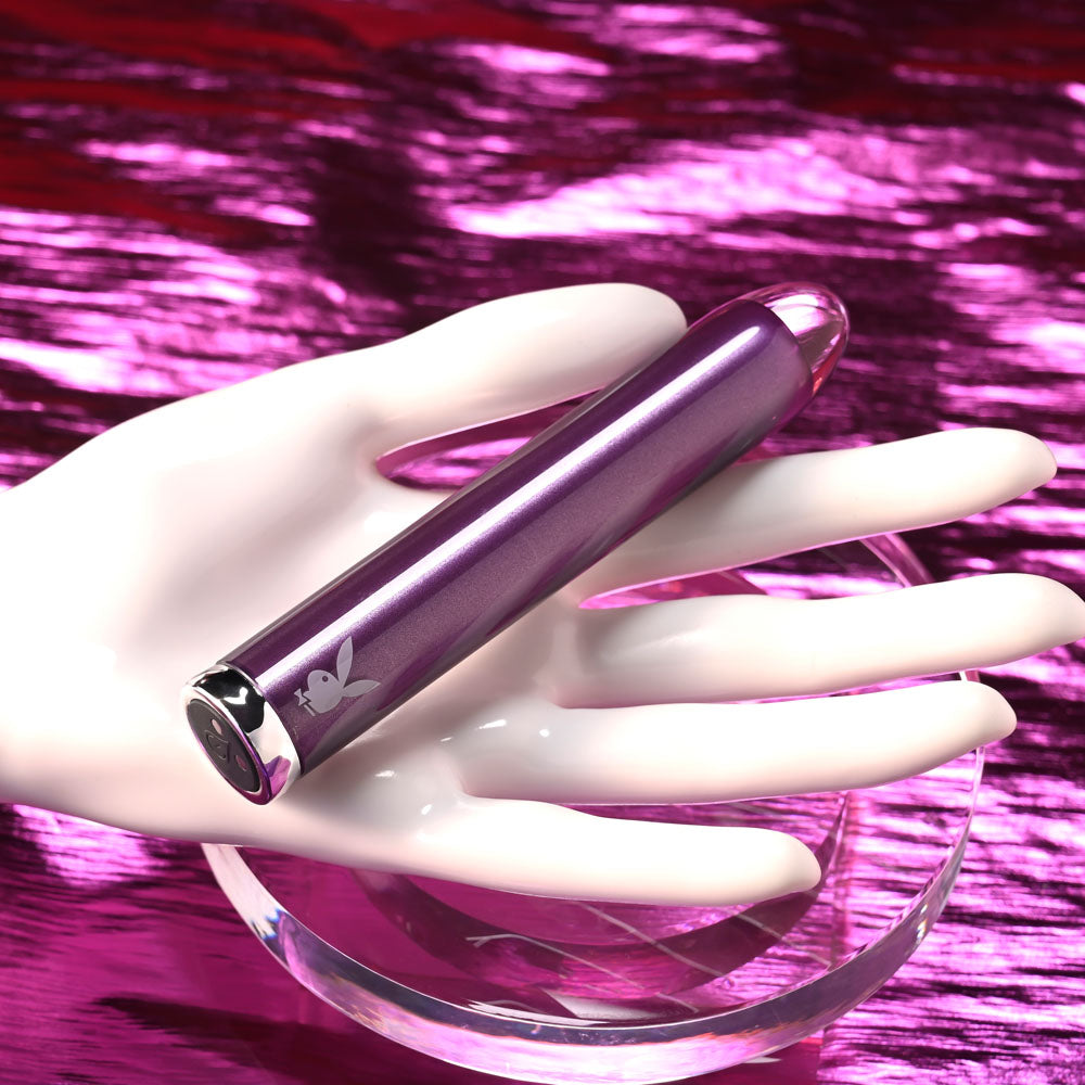 Playboy Pleasure AMETHYST - 12.4 cm USB Rechargeable Glass Tipped Mini Vibrator on display in a hand