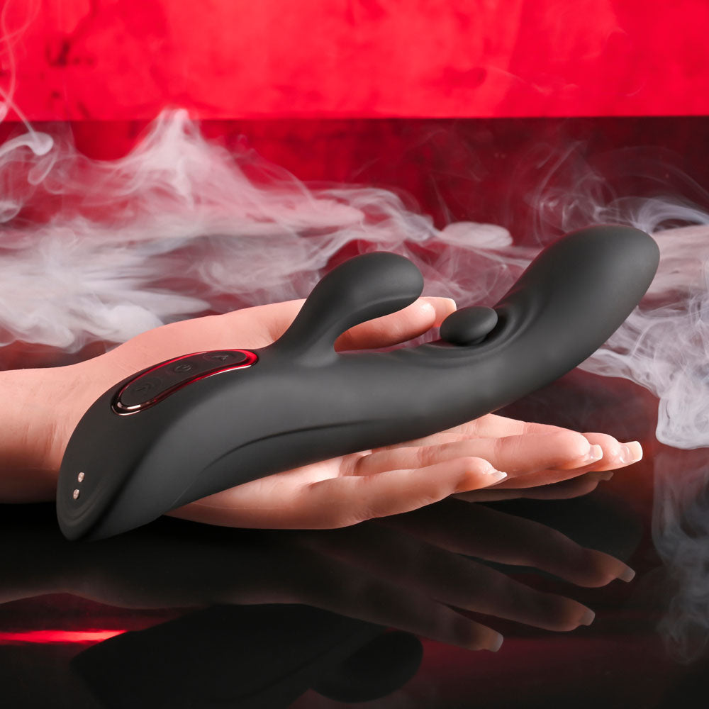 Playboy Pleasure THATS THE SPOT - 23.3 cm USB Rechargeable Rabbit Vibrator with G-Spot Tapper held in hand.