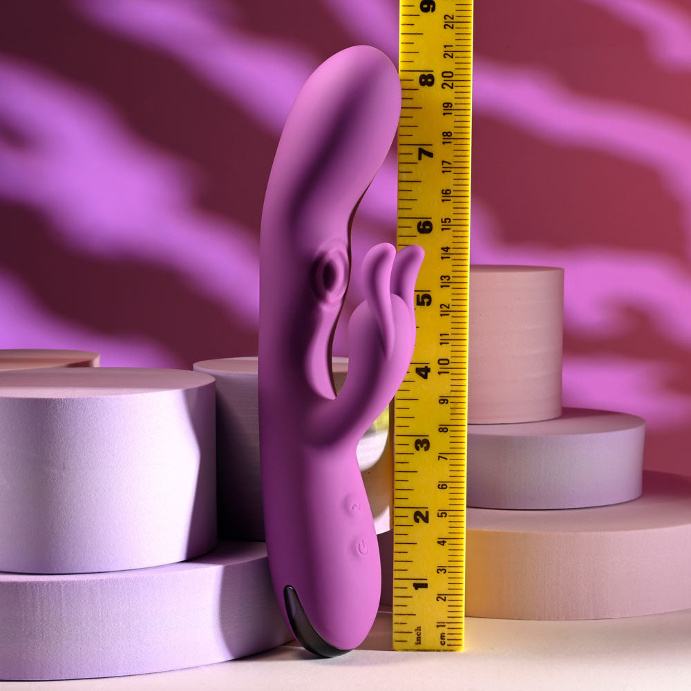 Playboy Pleasure BUSY BUNNY - 22.6 cm USB Rechargeable Rabbit Vibrator with Tapping Shaft standing next to a measuring tape.