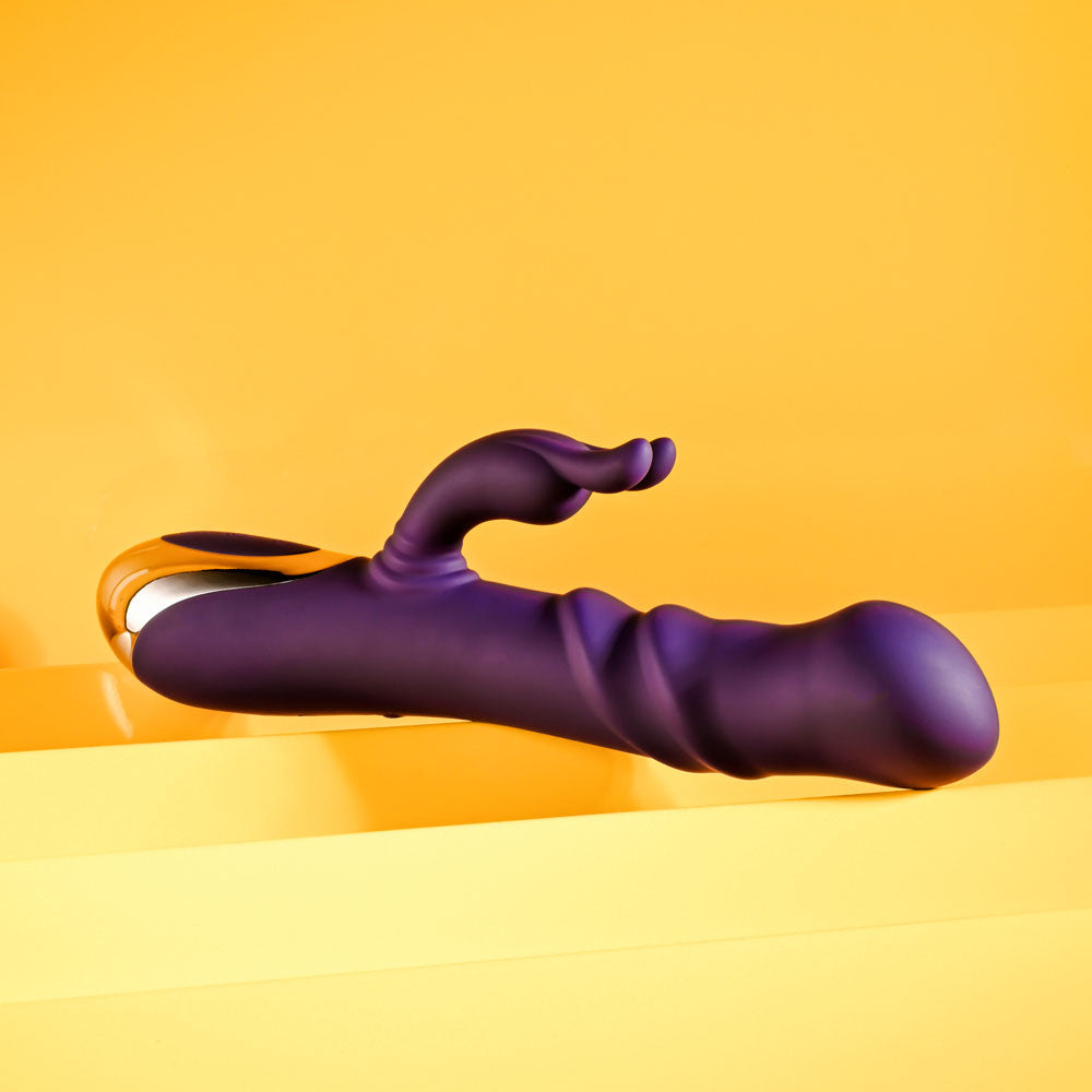 Playboy Pleasure BUNNY PUNCH - 24.4 cm USB Rechargeable Twirling Rabbit Vibrator on vibrant yellow background.