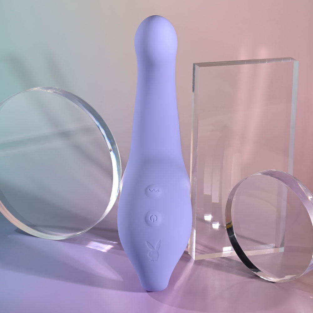 Playboy Pleasure NICE TO MEET YOU -  19.5 cm USB Rechargeable Vibrator showcasing its sleek design amidst clear acrylic shapes.