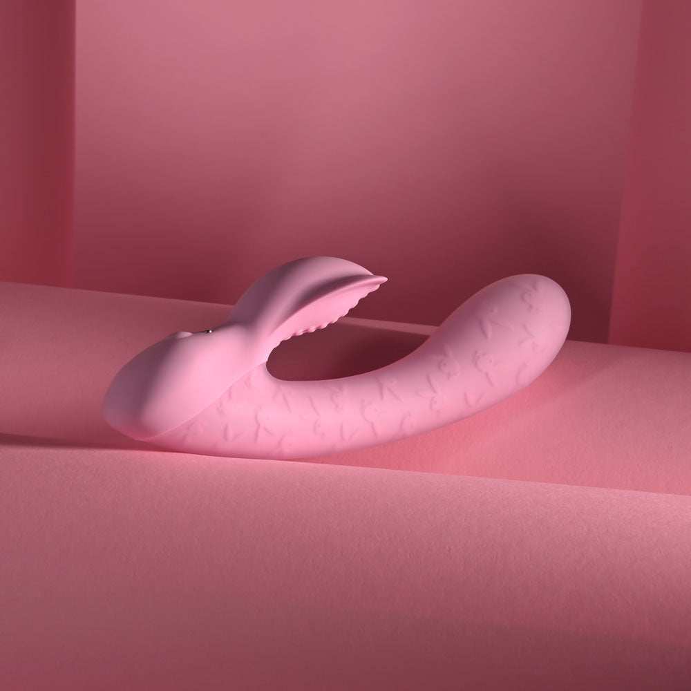 Playboy Pleasure RABBIT PARTY -  15.2 cm USB Rechargeable Rabbit Vibrator on pastel pink background.