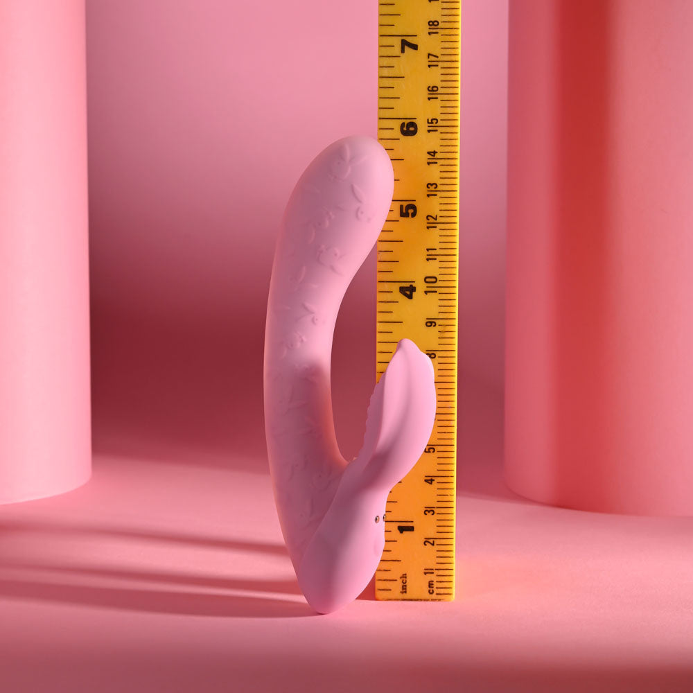 Playboy Pleasure RABBIT PARTY -  15.2 cm USB Rechargeable Rabbit Vibrator next to a measuring tape on a pink background.