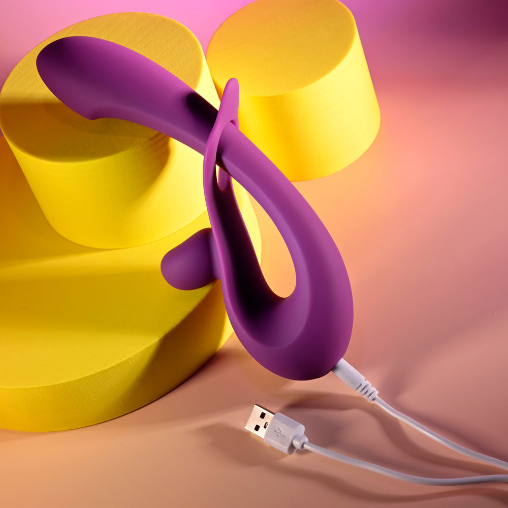 Playboy Pleasure CHA CHA SLIDE -  20 cm USB Rechargeable Rabbit Vibrator on yellow and pink background.